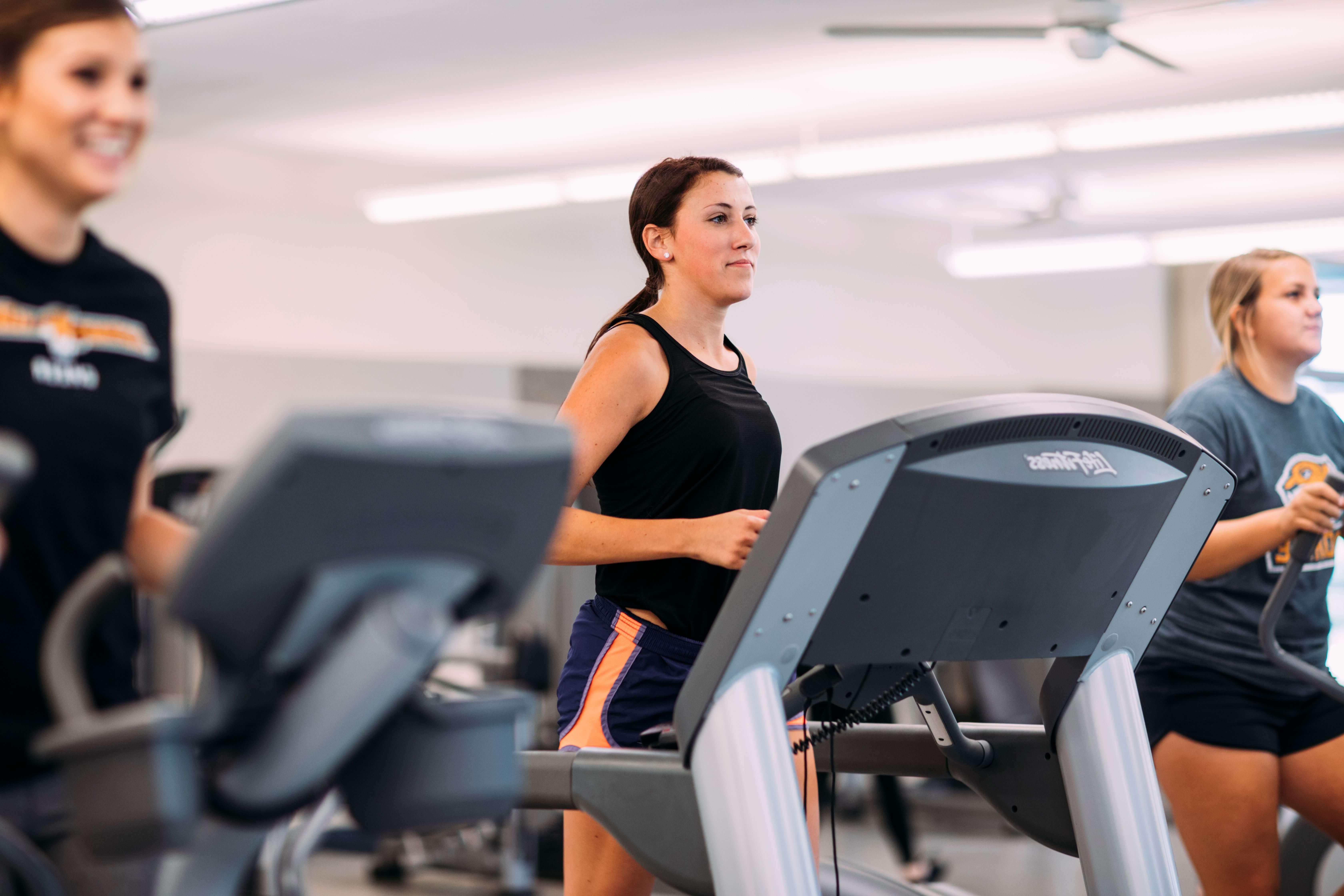 Students using gym equipment